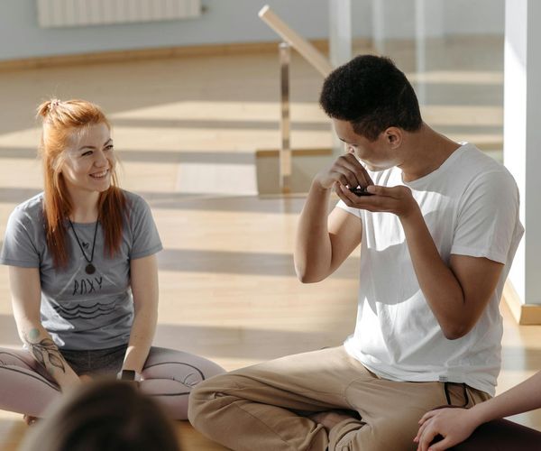 A diverse group of people practicing yoga in a bright studio.