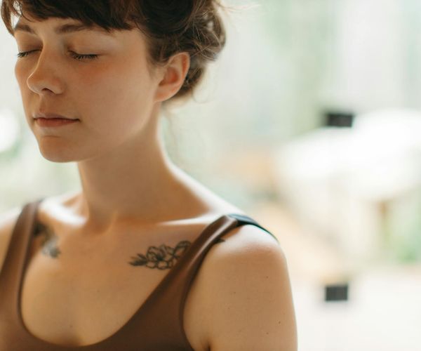 Close-up of a person's serene face, focusing on mindful breathing.